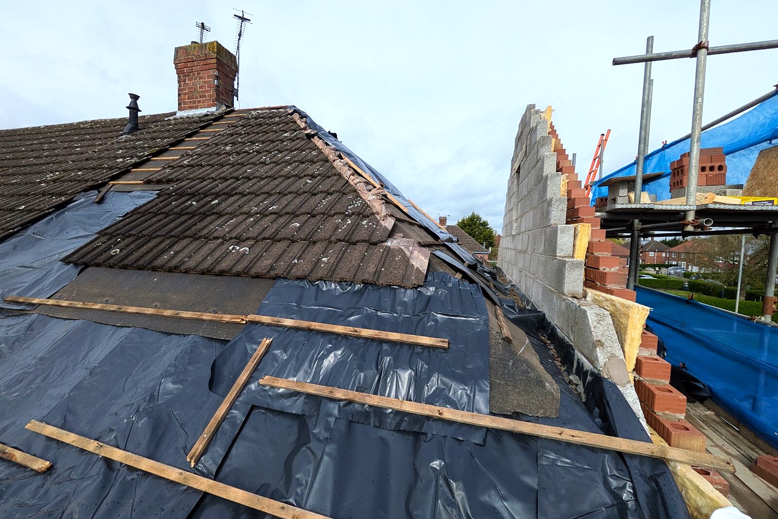 Roof stripped back to felt and battens with the gable wall being built up
