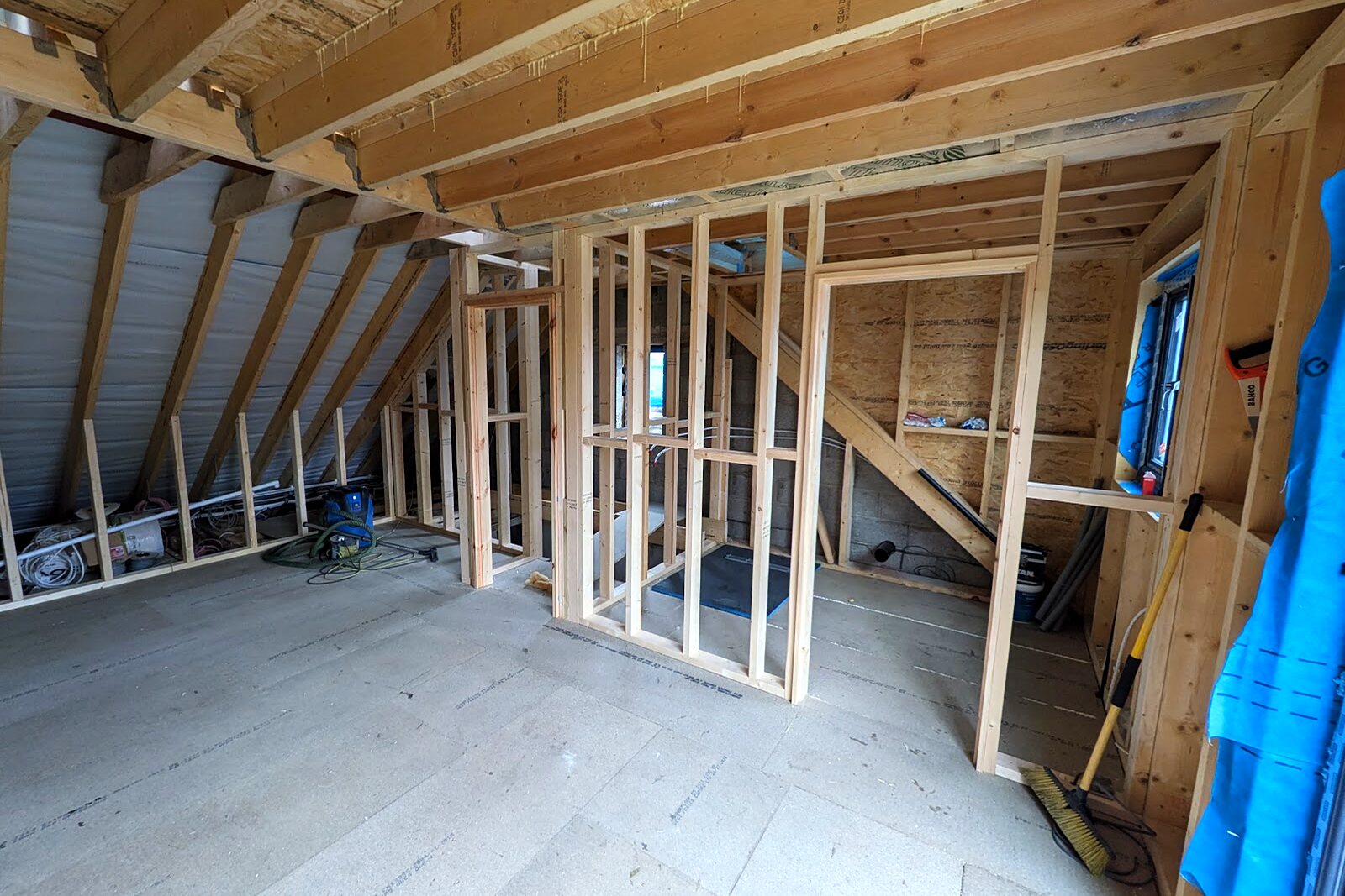 Interior of the loft with new stud walls and exposed timber structure