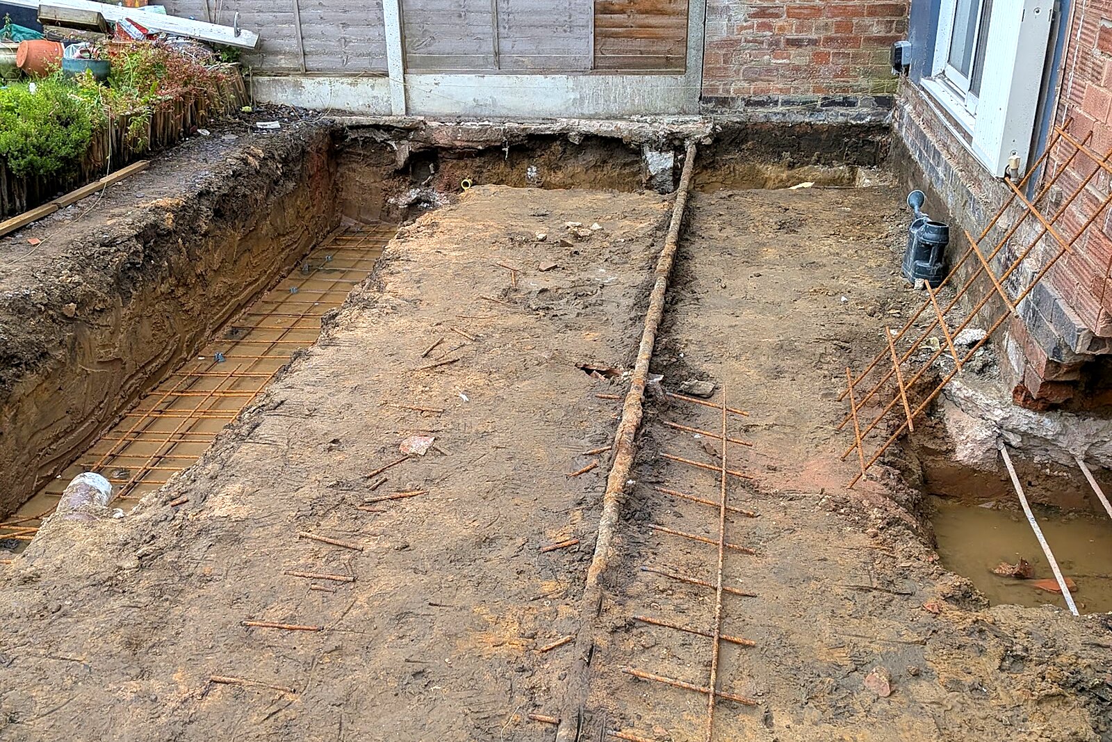Excavated foundation trenches along the rear of the property