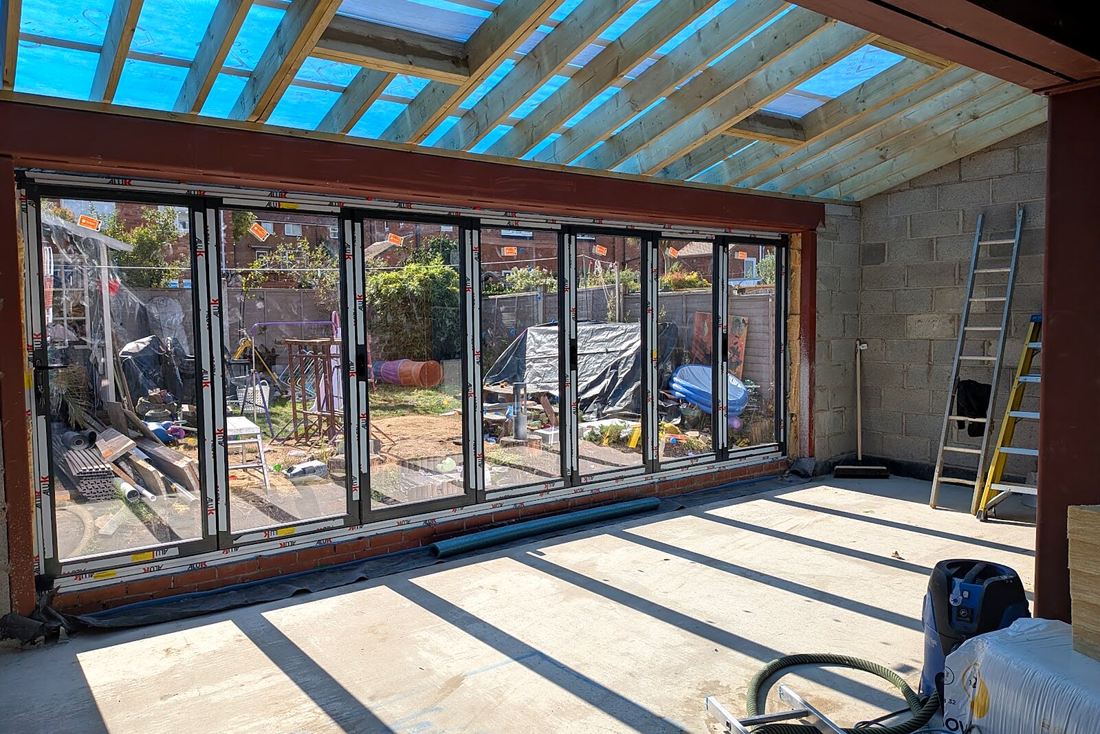 Inside the new extension with rooflights and bifold doors before plastering