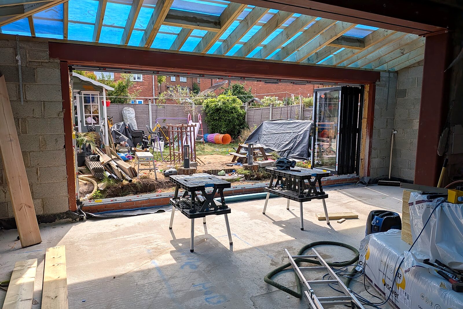Open-plan rear extension with full-width aluminium bifold doors opening onto a garden in Acomb, York