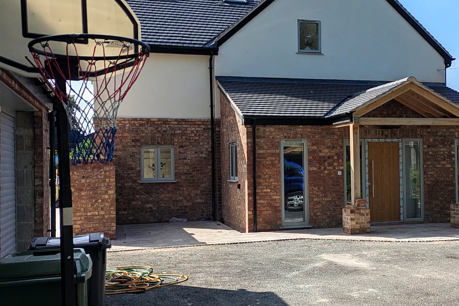 Completed renovated house exterior with new roof, render and driveway